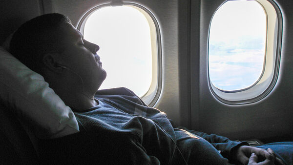 article airplane passenger sleeping