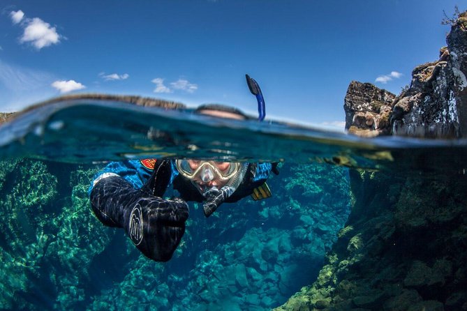 a person in a scuba diving suit underwater in Silfra Snorkeling