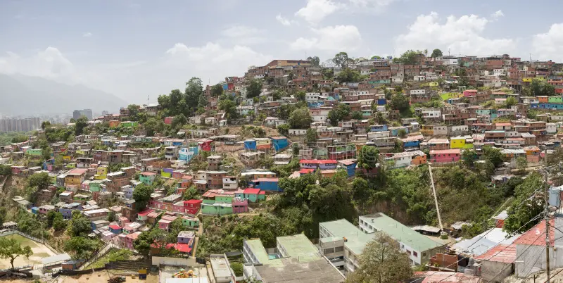 slum district caracas small wooden coloured houses poor neighborhood cover hills around 56773978